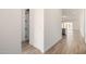 Hallway featuring tile flooring that leads to the kitchen and living spaces at 18174 W Ashley Dr, Goodyear, AZ 85338
