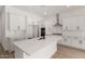 Bright kitchen with white cabinets, island, stainless steel appliances, and subway tile backsplash at 18174 W Ashley Dr, Goodyear, AZ 85338