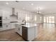 Spacious open kitchen with island, pendant lighting, stainless appliances, and ample cabinet space at 18174 W Ashley Dr, Goodyear, AZ 85338