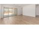 Living area featuring a glass sliding door to the patio and light tile flooring at 18174 W Ashley Dr, Goodyear, AZ 85338