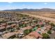 Wide aerial shot of a desert community with well-maintained homes and mountain views in the distance at 18390 W Hayden Dr, Surprise, AZ 85374