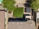 Aerial view of a backyard with artificial turf, a small pergola, and a stone border at 18390 W Hayden Dr, Surprise, AZ 85374