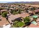 Aerial view of backyard featuring artificial grass, mature trees and ample space for outdoor living at 18390 W Hayden Dr, Surprise, AZ 85374