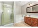 Bathroom featuring a glass door shower, bathtub, vanity and wooden drawers at 18390 W Hayden Dr, Surprise, AZ 85374