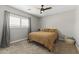 Bedroom featuring a comfy bed, window with shutter and gray curtains, and a ceiling fan at 18390 W Hayden Dr, Surprise, AZ 85374