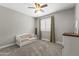 Bedroom with daybed, ceiling fan, window, and soft neutral colors at 18390 W Hayden Dr, Surprise, AZ 85374