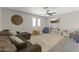 Upstairs bonus room featuring neutral carpet, a ceiling fan and plenty of natural light at 18390 W Hayden Dr, Surprise, AZ 85374