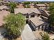 Two-story home featuring a well-manicured lawn, a two-car garage and desert landscaping at 18390 W Hayden Dr, Surprise, AZ 85374
