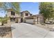 Charming two-story home featuring a three-car garage and a well-maintained front yard with mature trees at 18390 W Hayden Dr, Surprise, AZ 85374