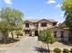 Beautiful two-story home featuring a well-maintained front yard and a spacious driveway at 18390 W Hayden Dr, Surprise, AZ 85374