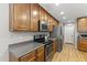 Functional kitchen with wood cabinetry, wood floors, and stainless steel appliances for modern convenience at 18390 W Hayden Dr, Surprise, AZ 85374