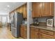 Stylish kitchen showcasing stainless steel refrigerator and wood cabinets for ample storage at 18390 W Hayden Dr, Surprise, AZ 85374