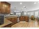 Modern kitchen featuring wood cabinets, stainless steel appliances, and wood floors, and open layout at 18390 W Hayden Dr, Surprise, AZ 85374