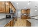 Well-equipped kitchen boasting stainless steel appliances, wood cabinets, and wood flooring at 18390 W Hayden Dr, Surprise, AZ 85374
