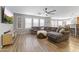 Cozy living room showcasing a spacious sectional, wood flooring, and bright natural light at 18390 W Hayden Dr, Surprise, AZ 85374