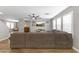 Spacious living room featuring wood floors, neutral tones, and a ceiling fan at 18390 W Hayden Dr, Surprise, AZ 85374