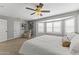 Bright main bedroom with a ceiling fan, and large bay window offering ample natural light at 18390 W Hayden Dr, Surprise, AZ 85374