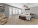 Spacious main bedroom features plush carpeting, bay windows, a ceiling fan, and neutral decor at 18390 W Hayden Dr, Surprise, AZ 85374