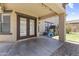 Covered patio area with string lights and outdoor seating next to a well-manicured backyard at 18390 W Hayden Dr, Surprise, AZ 85374