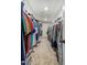 Long walk-in closet filled with clothing racks and organized storage solutions at 18390 W Hayden Dr, Surprise, AZ 85374