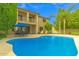 A sparkling pool and patio area, perfect for entertaining, behind a two-story home at 1951 W Bartlett Ct, Chandler, AZ 85248