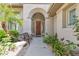 Inviting front entrance with an arched doorway, wood door, and charming bench at 1951 W Bartlett Ct, Chandler, AZ 85248