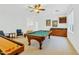 A spacious game room features a billiard table, shuffle board and wet bar for entertaining guests at 1951 W Bartlett Ct, Chandler, AZ 85248