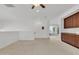 Open loft area with built-in cabinets, neutral carpet, and bright lighting at 1951 W Bartlett Ct, Chandler, AZ 85248