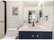 Bathroom featuring navy blue vanity with modern fixtures and white walls at 2026 E Cortez Dr, Gilbert, AZ 85234