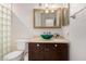 Powder room featuring modern fixtures, a vanity with vessel sink, and a decorative mirror at 2026 E Cortez Dr, Gilbert, AZ 85234