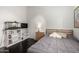Comfortable bedroom with wood floors, a cozy bed, and a large bookcase at 2026 E Cortez Dr, Gilbert, AZ 85234