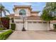 Charming two-story home with a three-car garage, red tile roof, basketball hoop and beautiful desert landscaping at 2026 E Cortez Dr, Gilbert, AZ 85234