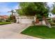 Beautiful home with a three-car garage, basketball hoop, and lush landscaping for added curb appeal at 2026 E Cortez Dr, Gilbert, AZ 85234