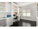 Bright home office featuring custom built-ins, white cabinets, and dark wood floors at 2026 E Cortez Dr, Gilbert, AZ 85234
