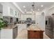 Kitchen with granite countertops, large center island, stainless steel appliances, and decorative pendant lighting at 2026 E Cortez Dr, Gilbert, AZ 85234