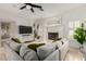 Bright living room with a fireplace, a plush sectional sofa, and natural light from windows and sliding glass door at 2026 E Cortez Dr, Gilbert, AZ 85234