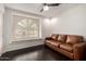 Relaxing living room boasts hardwood floors, a leather sofa, and a window seat at 2026 E Cortez Dr, Gilbert, AZ 85234