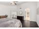 Spacious main bedroom featuring dark wood floors, white walls, and arched doorway leading into main bathroom at 2026 E Cortez Dr, Gilbert, AZ 85234