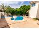 Backyard features a refreshing private pool, lush landscaping, and outdoor seating under a sunny blue sky at 2026 E Cortez Dr, Gilbert, AZ 85234