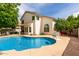 Backyard pool with concrete patio surrounded by mature trees at 2026 E Cortez Dr, Gilbert, AZ 85234