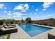 Inviting backyard pool with lounge chairs to bask in the sun and desert landscaping for a peaceful escape at 22925 N 46Th St, Phoenix, AZ 85050