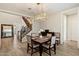 Open dining area with elegant chandelier adjacent to staircase and entry, with stylish flooring throughout at 22925 N 46Th St, Phoenix, AZ 85050