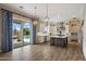 Open kitchen with stainless steel appliances and island next to the sliding glass doors to the backyard at 22925 N 46Th St, Phoenix, AZ 85050