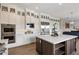 Bright kitchen with custom white cabinetry, stainless steel appliances, and a large kitchen island at 22925 N 46Th St, Phoenix, AZ 85050