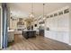 Spacious kitchen featuring white cabinets, stainless steel appliances, and a large center island at 22925 N 46Th St, Phoenix, AZ 85050
