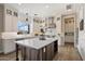 Modern kitchen featuring white cabinets, stainless steel appliances, and a large center island at 22925 N 46Th St, Phoenix, AZ 85050