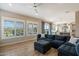 Open-concept living space with wood flooring, plantation shutters, and views into the adjoining kitchen at 22925 N 46Th St, Phoenix, AZ 85050