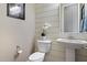 Stylish powder room with shiplap accent wall, pedestal sink, and modern fixtures at 22925 N 46Th St, Phoenix, AZ 85050