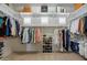 Spacious walk-in closet with shelves, hanging rods, windows, and shoe racks providing ample storage at 22925 N 46Th St, Phoenix, AZ 85050