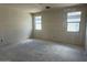 New construction bedroom featuring drywall walls, concrete flooring, and double hung windows at 2300 E Spur Dr, San Tan Valley, AZ 85140